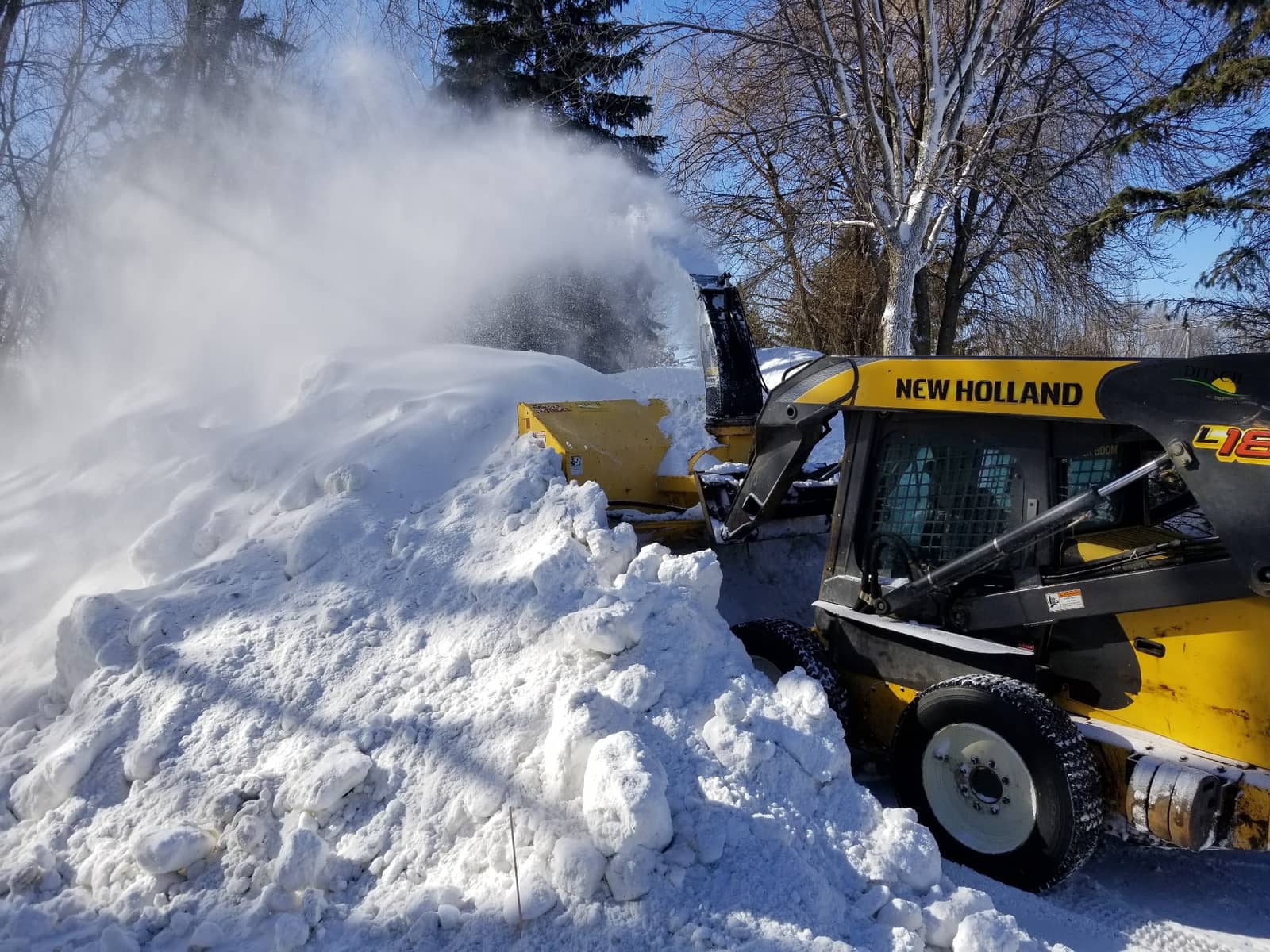 Liberty Lawn & Snow skid steer with snow blower attachment clearing a heavy snowfall in the West Metro